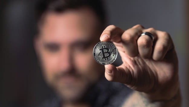 man holding a type of virtual currency